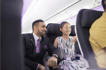 Onboard-Flight-Attendant-helping-child-4316-1200x800