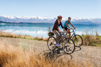 Couple cycling on the Ocean Cycle Trail at Lake Pukaki