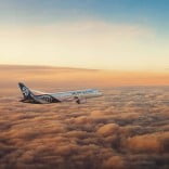 Air New Zealand 787-9 flying above the clouds at dusk. 
