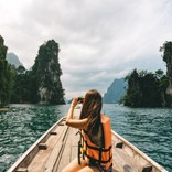 Woman photographing, Khao Sok National Park, Thailand.