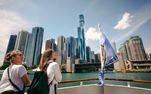 Two people admiring the view while cruising the Chicago River in Chicago, USA