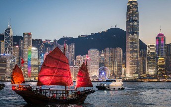A traditional junk boat sailing across Victoria Harbour in Hong Kong