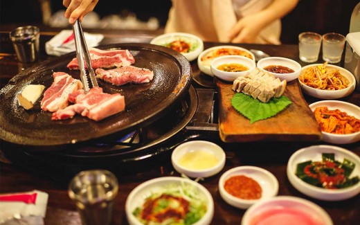 A typical Korean BBQ with meat and sides in Seoul, Korea