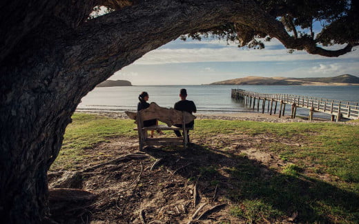 A couple enjoying the view at Hokianga Harbour, New Zealand