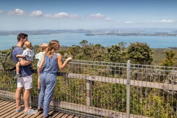 A family admiring the view from the top of Rangitoto.