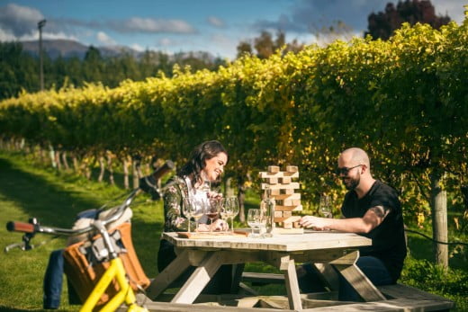 Couple drinking wine at Forrest Estate Winery, Marlborough, New Zealand.