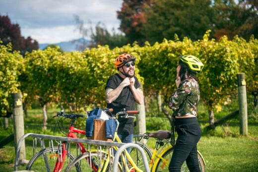 Couple with bicycles at Forrest Estate Winery, Marlborough, New Zealand.