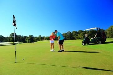 Couple on golf course, Sunshine Coast, Australia. 