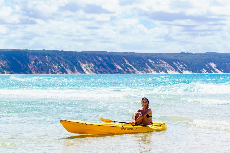 Lady in canoe, Rainbow Beach, Sunshine Coast, Australia. 