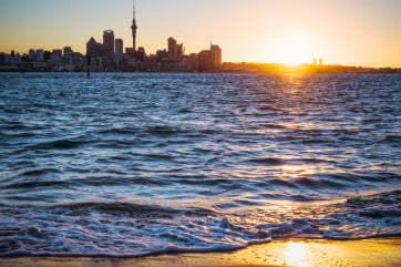 New Zealand Auckland skyline at sunset from Devonport Beach. 