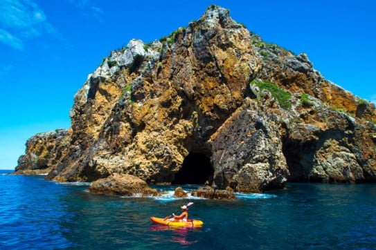 Paddleboarders at Poor Knights Islands, Northland, New Zealand. 