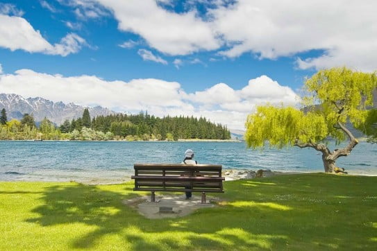 Lady sitting by lake, Queenstown. 