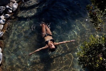 Lady relaxing in a hot pool, Polynesian Spa, Rotorua. 