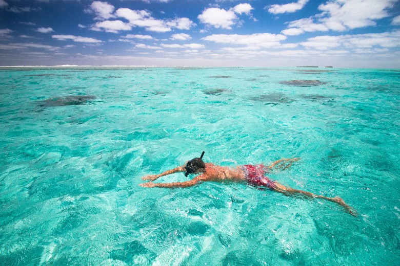 Snorkelling in clear water, Rarotonga, Cook Islands. 