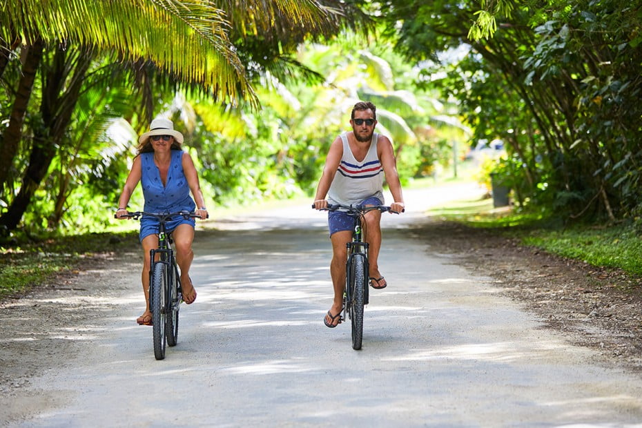 Couple biking in Alofi, Niue.