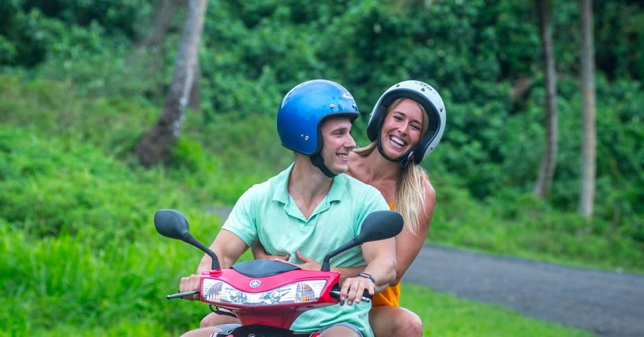 Couple on a scooter with helmets, Rarotonga. 