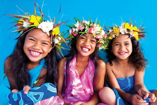Three Rarotongan girls smiling, Cook Islands. 