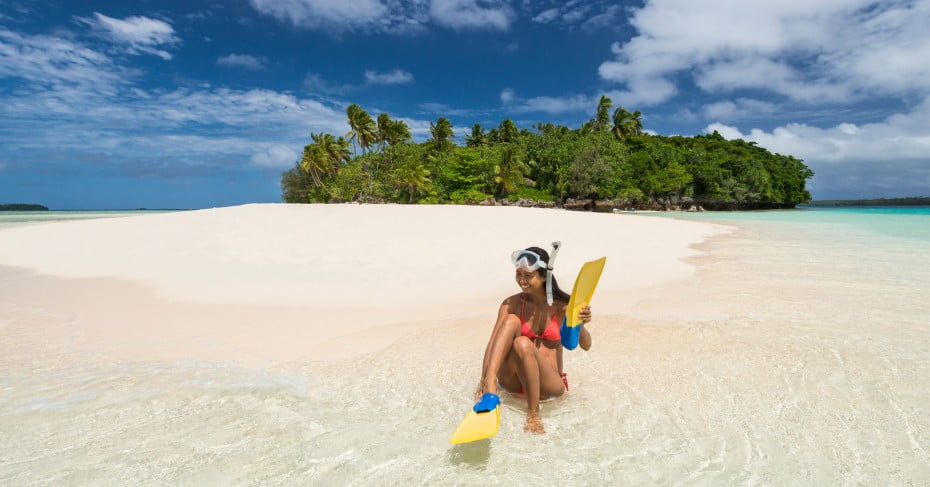 Woman in snorkel gear on Tongan beach, Pacific Islands.