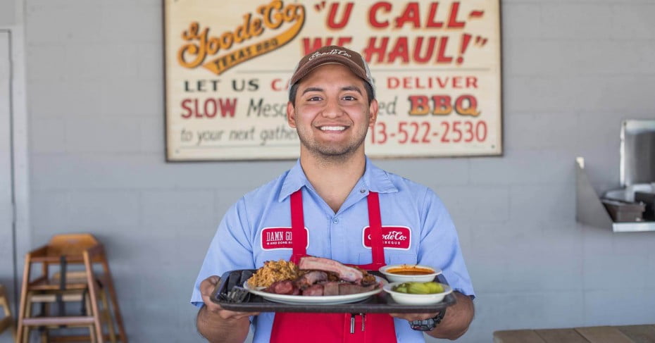 A waiter with a Texan BBQ plate, Texas. 