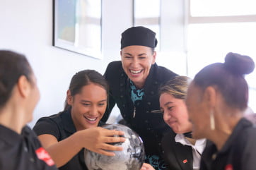 Queenstown Resort College students with Air NZ employee. 