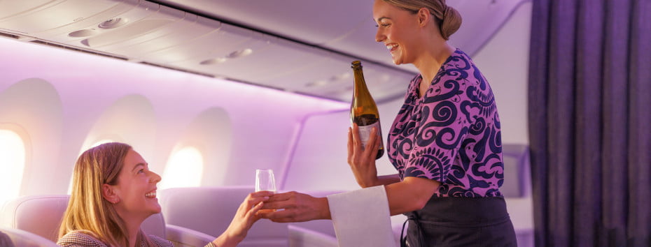 new-zealand-flight-attending-serving-glass-of-wine-business-premier-nc-rf-noexp-allsites-2100x800px.jpg