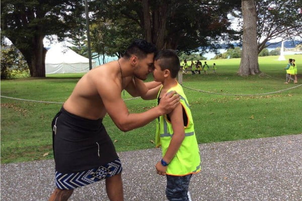 Hedgehope School student performing hongi with cultural leader at Waitangi Treaty Grounds 