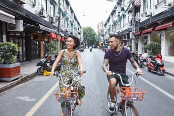 Tourists cycling through Former French Concession, Shanghai, China.