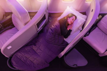passenger sleeping in business premier in bed mode.
